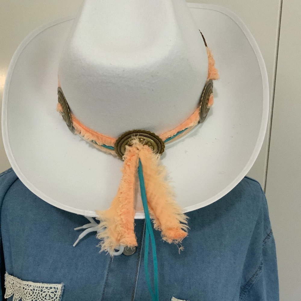Handmade hat band with frayed peach fabric and bronze conchos